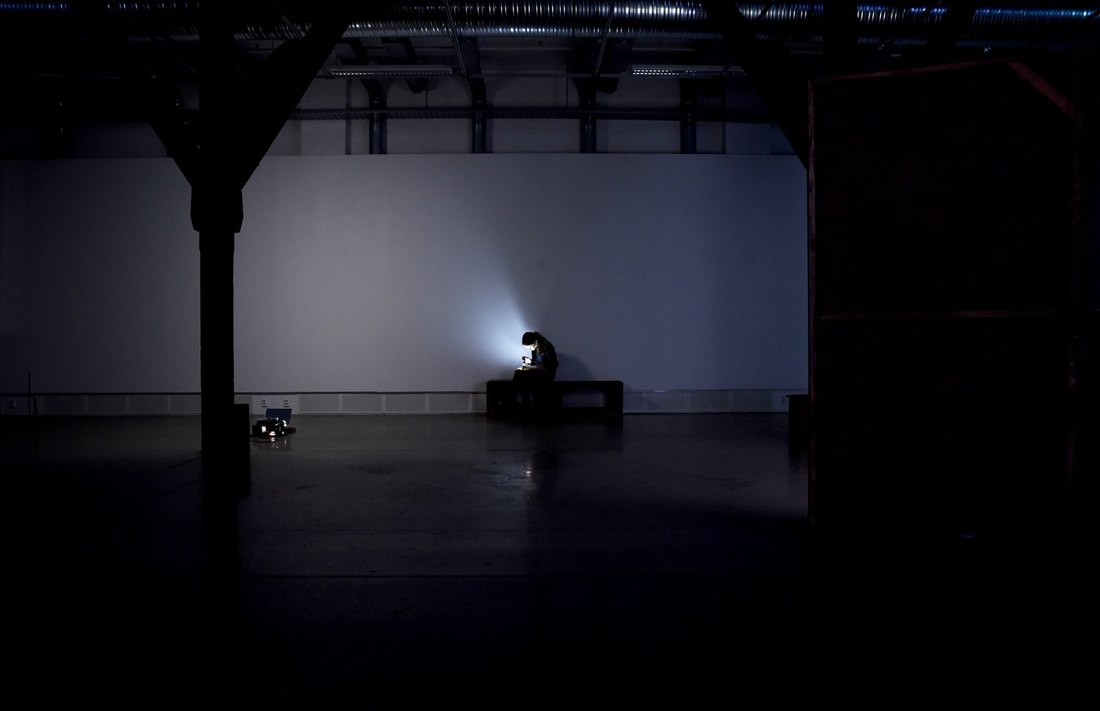 Installation view with flashlight-lit comicbook and seating by Anna Clawson